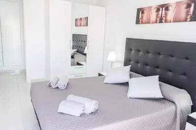 a bedroom with a bed with white towels on it at Apartamento Montroig 2 in Sitges