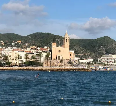 a view of a city from the water with a church at Apartamento Montroig 2 in Sitges