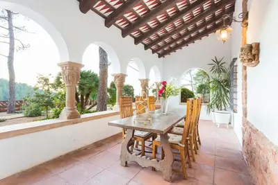 a dining room with a table and chairs at Luxury Villa El Turo in Castellví de Rosanés