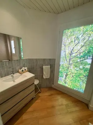 a bathroom with a sink and a large window at Spacious & Comfortable flat in centric Eixample in Barcelona