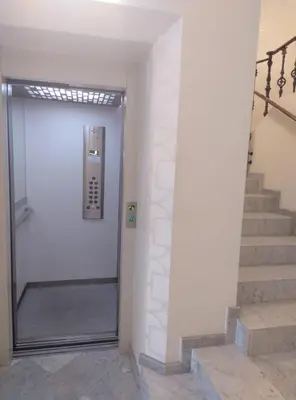 a elevator in a building with stairs and a door at Spacious & Comfortable flat in centric Eixample in Barcelona