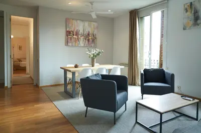 a living room with two chairs and a table at Spacious & Comfortable flat in centric Eixample in Barcelona