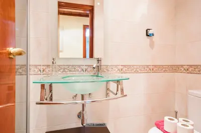 a bathroom with a glass sink and a mirror at Alcam Barbera Centro in Barbera del Valles