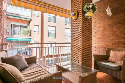 a balcony with a couch and chairs on a building at Alcam Barbera Centro in Barbera del Valles