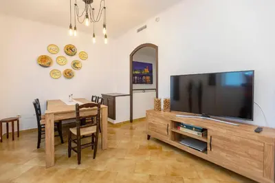 a living room with a television and a dining room table at 21 Sleeps Private Pool Villa & BBQ Near Barcelona in Rocafort