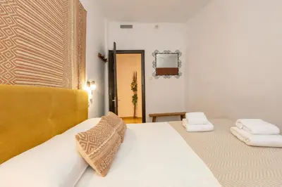 a bedroom with two beds with towels on them at 21 Sleeps Private Pool Villa & BBQ Near Barcelona in Rocafort