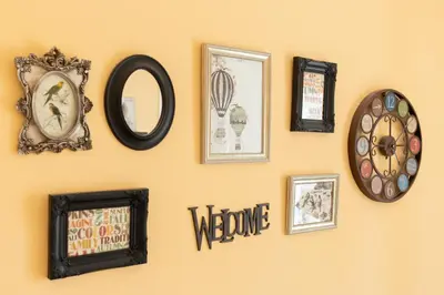 a wall with clocks and pictures on it at Housalia Guell & Gracia in Barcelona