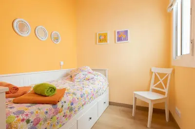 a childs bedroom with a bed and a chair at Housalia Guell & Gracia in Barcelona