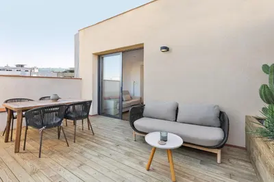 a living room with a couch and a table and chairs at Ola Living Calabria in Barcelona