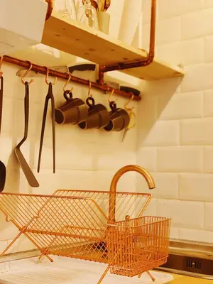 a kitchen with a basket and utensils on a wall at Arena Gold Euroviajeros apartaments in Pineda de Mar