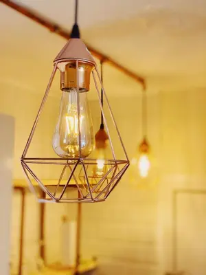 aendant light hanging from a ceiling in a room at Arena Gold Euroviajeros apartaments in Pineda de Mar