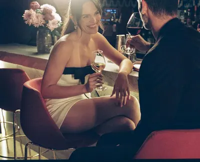 a woman sitting in a chair holding a glass of wine at Kimpton Vividora Hotel by IHG in Barcelona