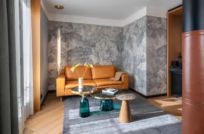 a living room with a couch and a table at Kimpton Vividora Hotel by IHG in Barcelona