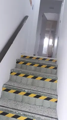 a staircase in a building with yellow and black at loft turistic in San Vicente dels Horts