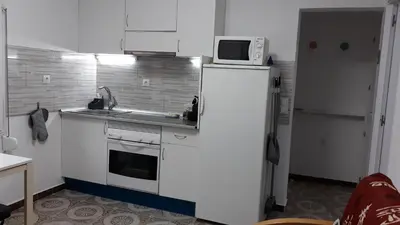 a kitchen with a microwave on top of a refrigerator at loft turistic in San Vicente dels Horts
