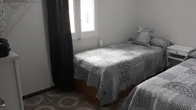 a bedroom with two beds and a window at loft turistic in San Vicente dels Horts
