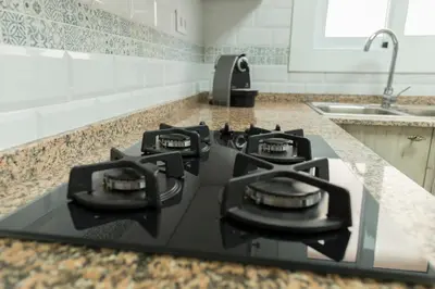 a black stove top in a kitchen with a sink at CUNIT HOME in Cunit