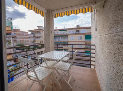 a table and chairs on a balcony with a view at CUNIT HOME in Cunit
