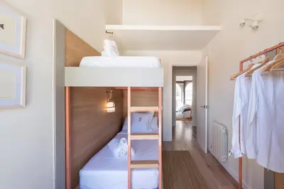 a bedroom with two bunk beds in a room at Petit Luxe Tobella Dreta in Terrassa