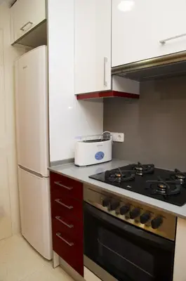 a kitchen with a stove and a refrigerator at Apartamentos Navas in Barcelona