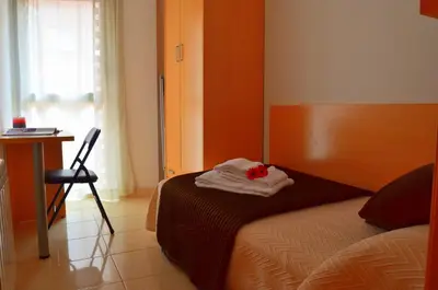 a bedroom with a bed and a table and a chair at Apartamentos Navas in Barcelona