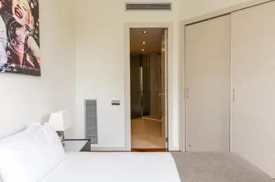 a bedroom with a bed and a walk in closet at Uma Suites Passeig de Gracia 16 in Barcelona