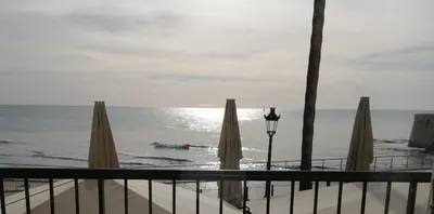 a view of a beach with umbrellas and the ocean at Port alegre - en el corazón de Sitges in Sitges