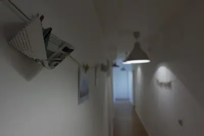 a hallway with a ceiling light and a hallway with a lightswitch at Monrooms Barcelona in Barcelona