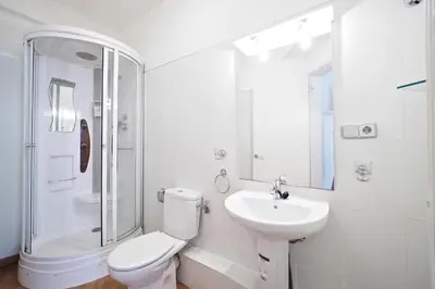 a white bathroom with a toilet and a sink at Monrooms Barcelona in Barcelona