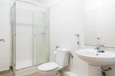 a white bathroom with a toilet and a sink at Monrooms Barcelona in Barcelona