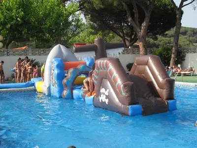 a group of inflatable slides in a swimming pool at Camping Roca Grossa in Calella