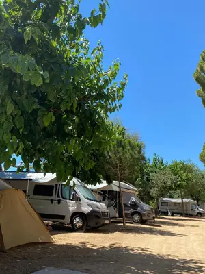 a group of tents and cars parked in a field at Camping Roca Grossa in Calella