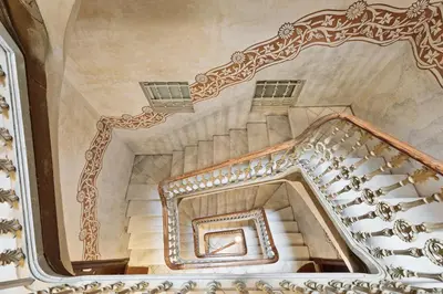 a spiral staircase in a building with a mirror at Apartments Barcelona & Home Deco Eixample in Barcelona