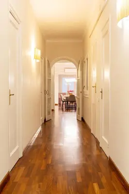 an empty hallway with a table and a dining room at Large & beautiful apartment 4min from Passeig de Gràcia in Barcelona