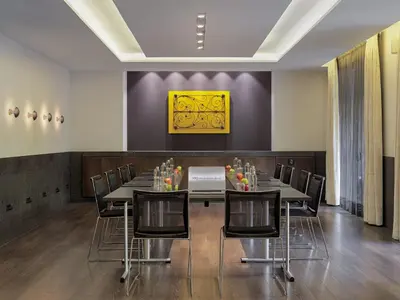 a conference room with a long table and chairs at H10 Urquinaona Plaza in Barcelona