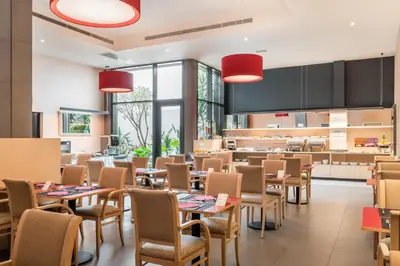 a restaurant with tables and chairs and a kitchen at Petit Palace Trencadís in Barcelona
