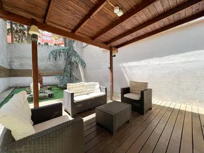 a deck with chairs and chairs on a patio at Home to Home Barcelona in Barcelona