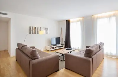 a living room with two couches and a tv at Durlet Beach Apartments in Barcelona