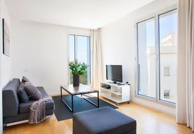 a living room with a couch and a tv at Durlet Beach Apartments in Barcelona