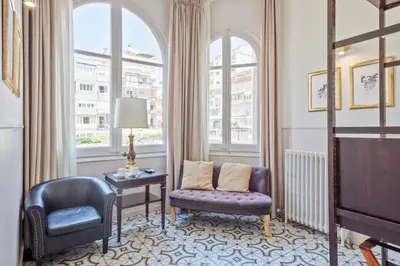 a living room with two chairs and a tv at Mihlton Barcelona Boutique B&B in Barcelona