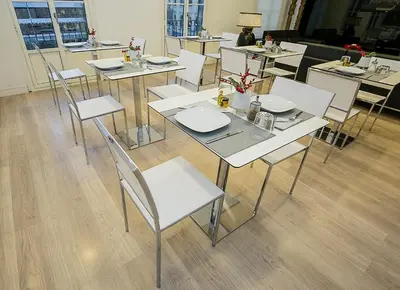 a dining room with white tables and white chairs at The 8 Boutique B&B in Barcelona