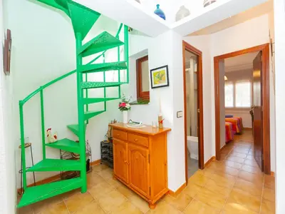 a green spiral staircase in a room with a bedroom at Holiday Home Remedios by Interhome in Cunit