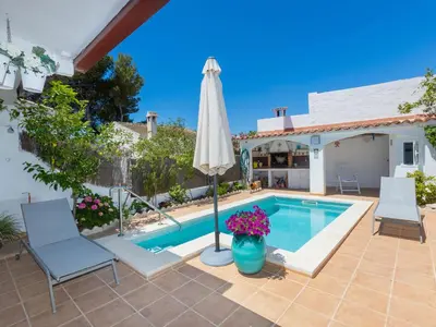 a patio with a pool and an umbrella at Holiday Home Remedios by Interhome in Cunit