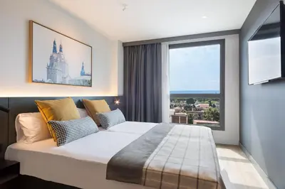 a bedroom with a large bed and a large window at Acta Voraport in Barcelona