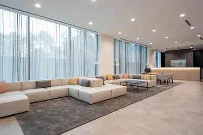 a living room with a couch and tables and windows at Acta Voraport in Barcelona