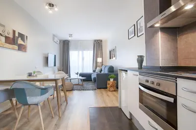 a kitchen and living room with a table and a stove at Tendency Apartments 8 in Barcelona