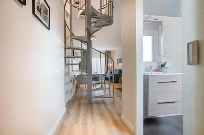 a spiral staircase in a living room with a dining room at Tendency Apartments 8 in Barcelona