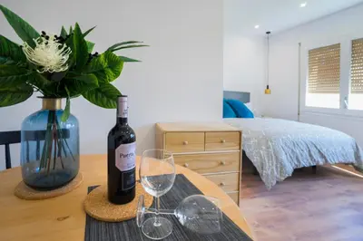 a table with a bottle of wine and glasses on it at Hotelito Boutique Badalona Mar in Badalona