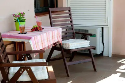 a table with a bowl of fruit and a table with two chairs at Alcam Barbera Terrazas in Barbera del Valles