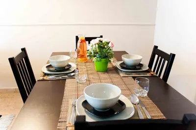 a table with plates and bowls on top of it at Alcam Barbera Terrazas in Barbera del Valles